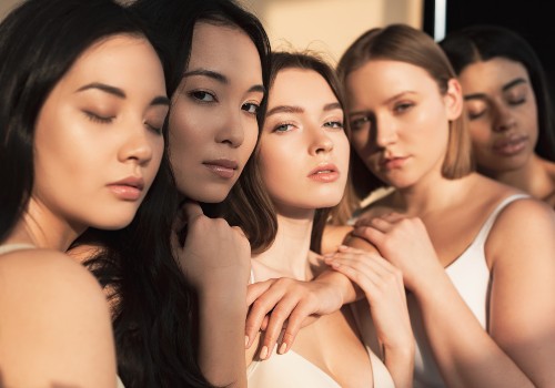 Five women with different skin tones posing together for a skincare portrait