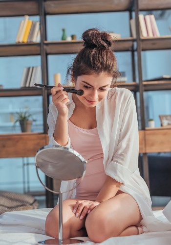 Beautiful girl looking at the mirror