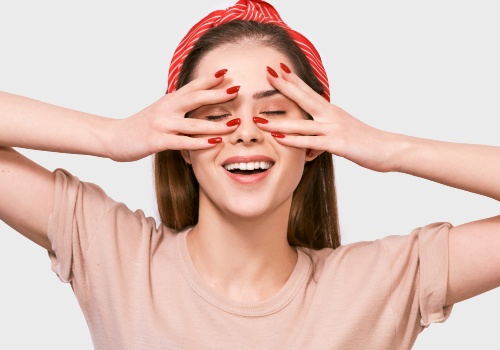 Beautiful young woman is doing face yoga