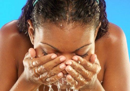 Woman is washing her face